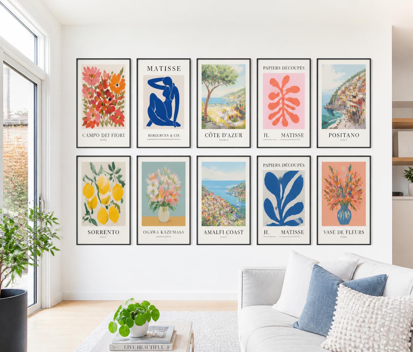 Bright living room wall filled with colourful framed poster prints
